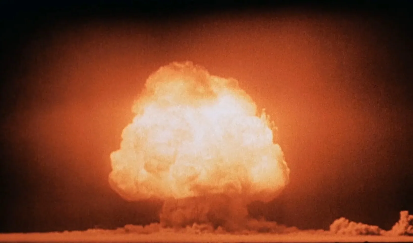 The Trinity test fireball expands above the desert in July 1945.
