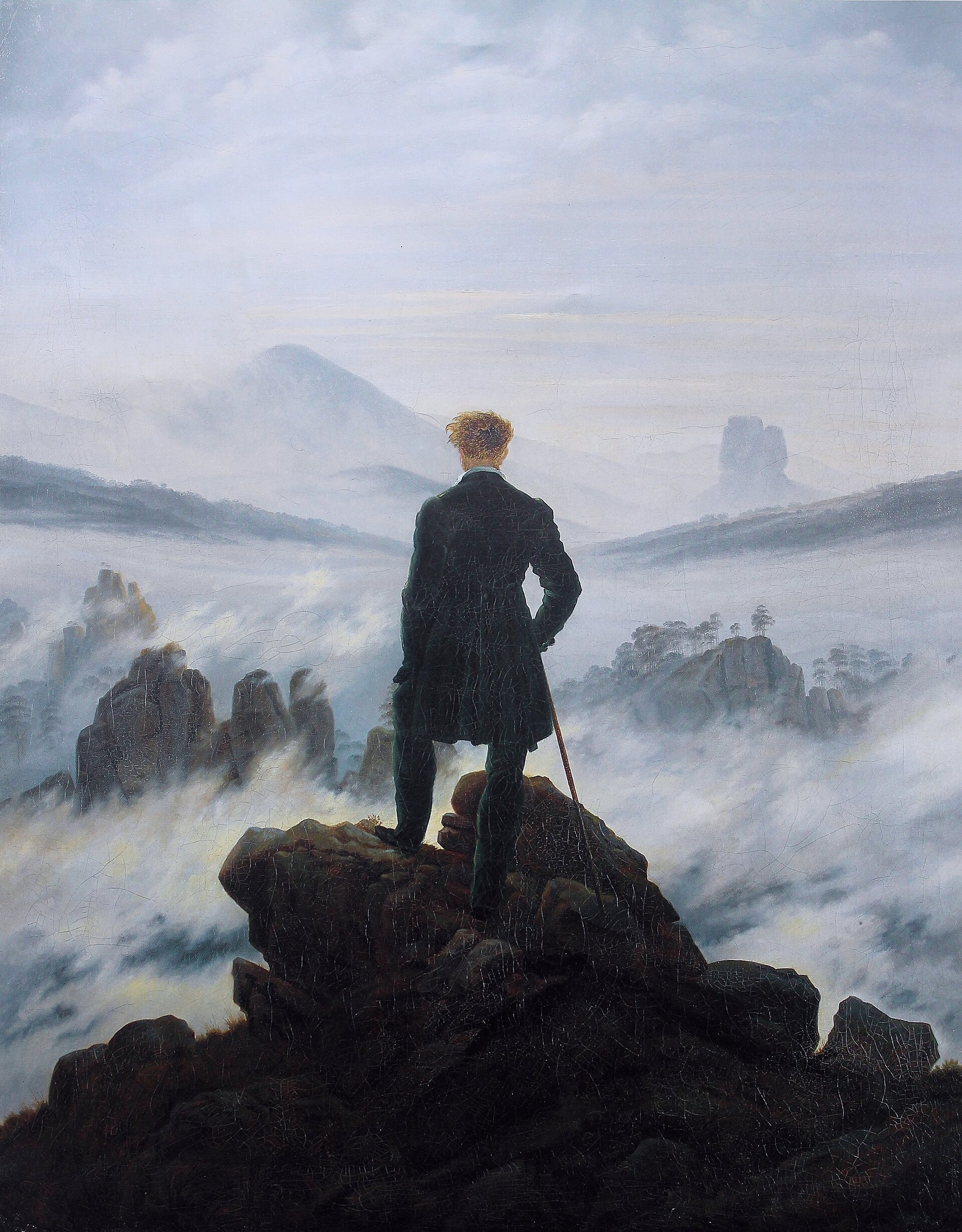 Caspar David Friedrich's Wanderer above the Sea of Fog, a lone figure on a rocky peak looking out over fog-filled valleys.