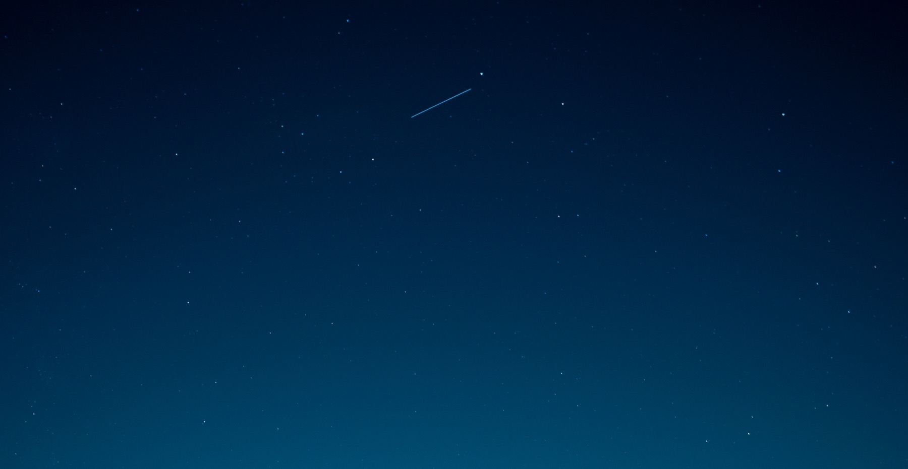 NASA Advanced Composite Solar Sail System seen as a bright point of light above Earth.