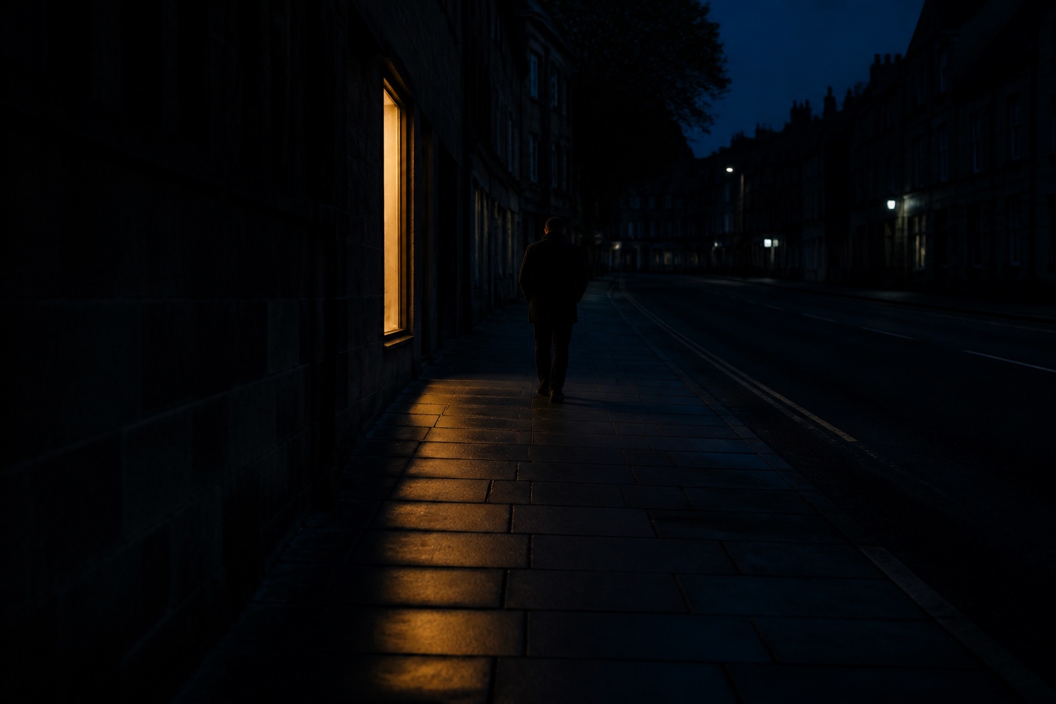 An imagined solitary person walking past one amber-lit window on a dark blue street.