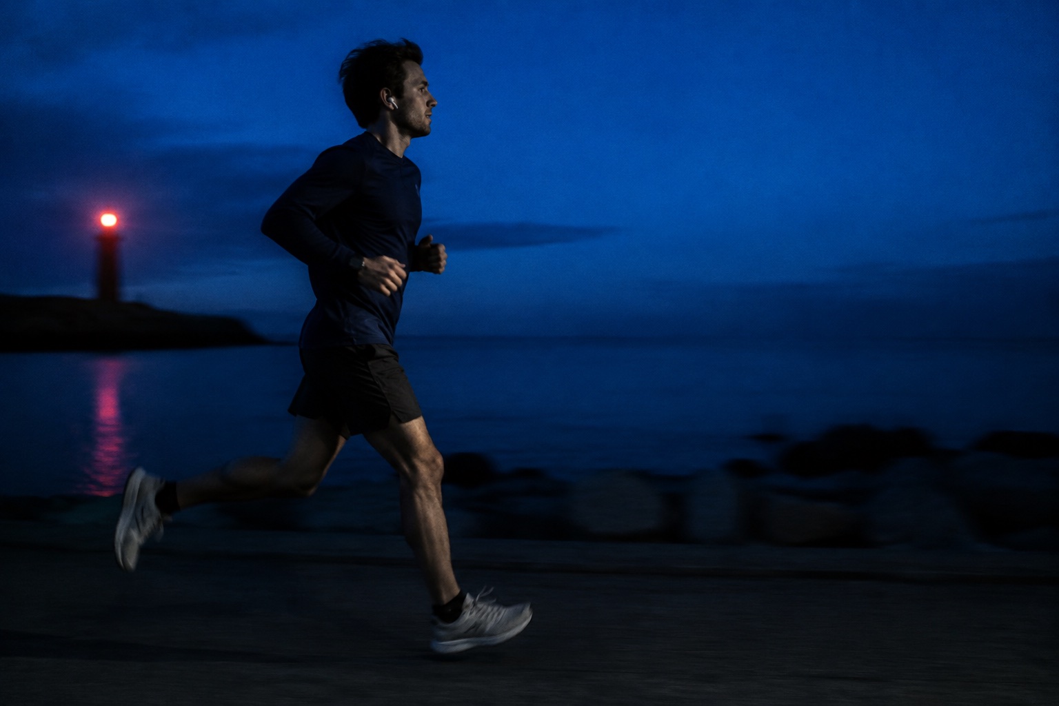 An imagined runner at dawn wearing a watch and a single earbud
